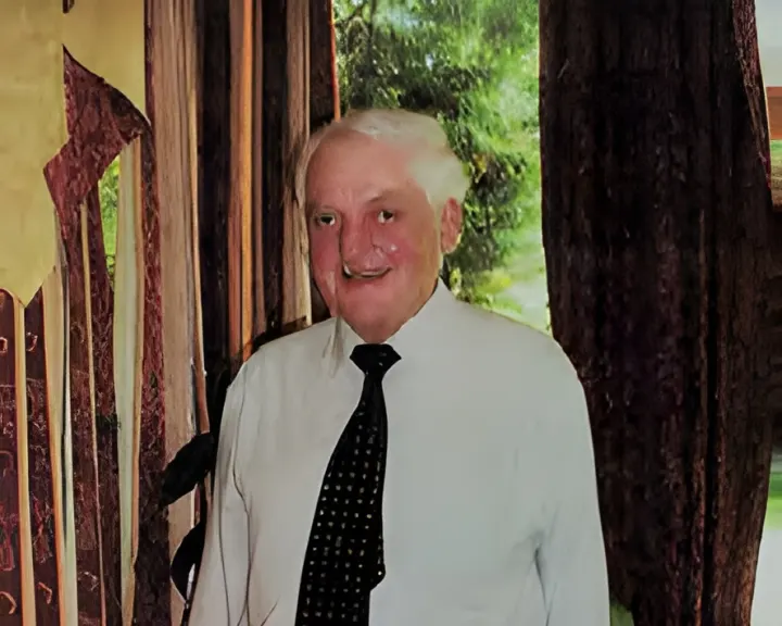 Portrait of a man in a white shirt and black tie